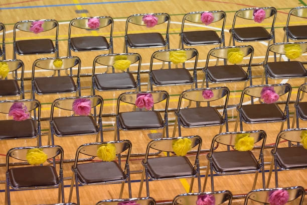 chars assembled in lines in a school gym.